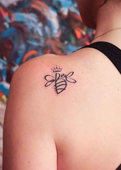 a woman with a bee tattoo on her back shoulder