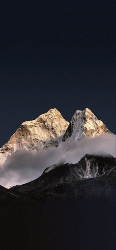 the mountains are covered in clouds at night