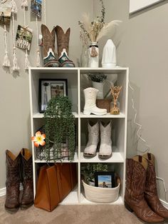 a shelf filled with lots of different types of shoes and bags on top of it