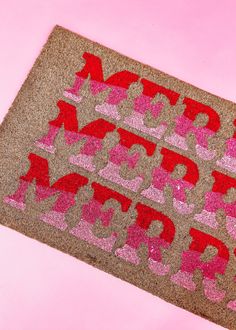 a pink and brown door mat with the words happy birthday written on it in red letters