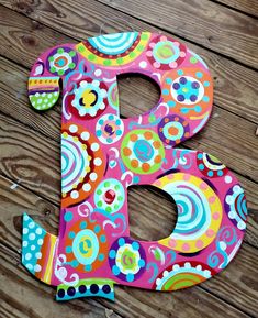 the letter b is decorated with colorful flowers and dots