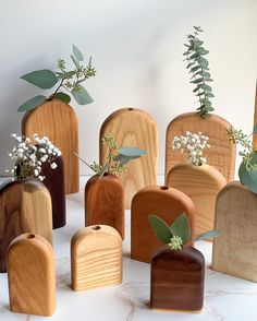 several wooden vases with plants in them