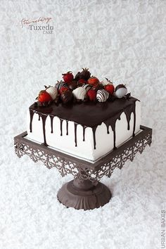 a white cake with chocolate and strawberries on top