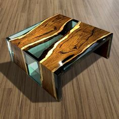 a table made out of wood and glass on top of a hard wood flooring