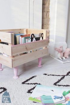 a child's toy storage unit with books and toys in it on the floor