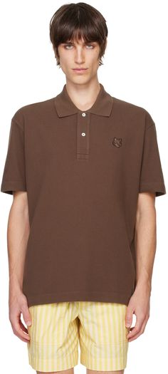 Cotton piqué polo. · Rib-knit spread collar · Two-button placket · Embroidered logo patch at chest · Vented side seams · Dropped shoulders Supplier color: Firewood Classic Brown Polo Shirt With Collared Neckline, Brown Cotton Polo Shirt With Polo Collar, Classic Brown Polo Shirt, Brown Cotton Polo Shirt, Collared Polo Shirt With Embroidered Logo For Work, Collared Polo Shirt With Embroidered Logo, Fox Head, Floral Shoes, Poncho Cape