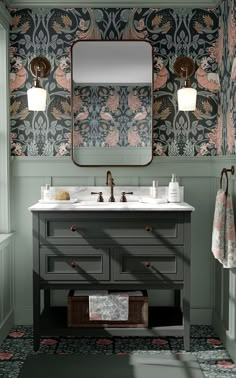 a bathroom with green walls and floral wallpaper