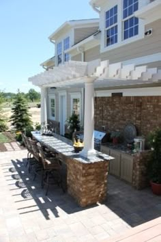 an outdoor kitchen and dining area is shown