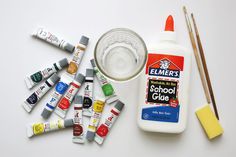 an assortment of school supplies including glue, paint and pencils