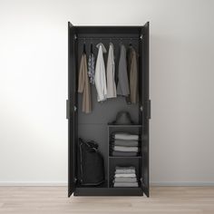 an open wardrobe with clothes hanging on it