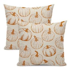 two pillows with pumpkins printed on them