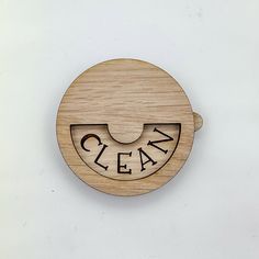 a wooden clock with the word clean on it's face and an open mouth