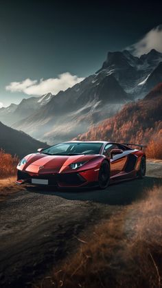 a red sports car parked on the side of a road in front of some mountains