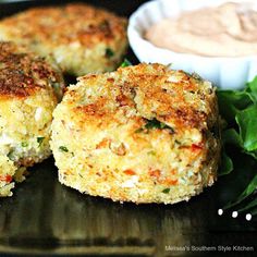 crab cakes on a plate with lettuce and dip