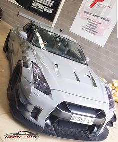 a silver sports car parked in a garage