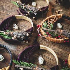 several baskets filled with different types of items on top of a wooden table next to pine cones