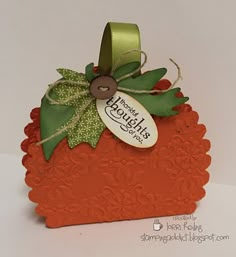 an orange card with a green bow and tag on it that says happy hough's day