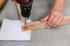 a person using a drill to cut wood