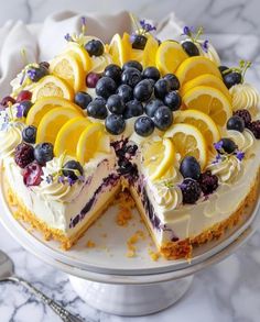 a lemon and blueberry cheesecake on a cake plate