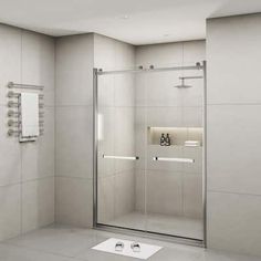 a bathroom with a glass shower door and white tile flooring, along with a towel rack on the wall