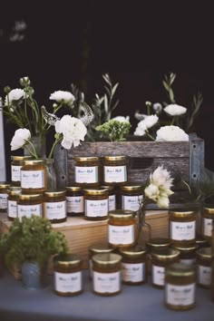 many jars of honey sit on a table