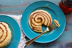 two blue plates topped with pancakes next to each other