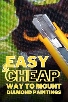 a close up of a person holding a pen with the words easy and cheap way to mount diamond paintings