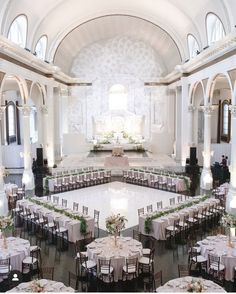 a large banquet hall with tables and chairs set up for a formal function in the center