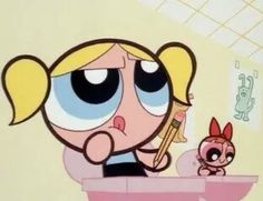 the powerpuff girls cartoon character is holding a toothbrush and looking at something