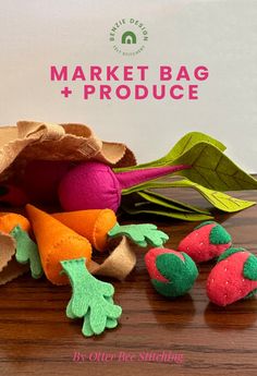 several felt vegetables and leaves on a table with the text market bag + produce written below