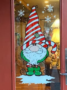 a glass door with a christmas gnome painted on it