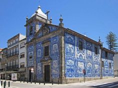 an old building with blue and white tiles on it