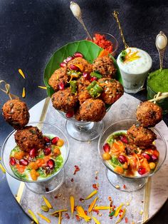 three small bowls filled with food on top of a table