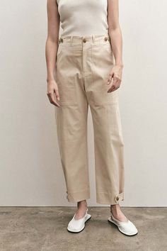 Mijeong park cropped workwear trousers in light beige. button and zipper fly front two front patch pockets one back patch pocket adjustable waist and bottom with button and tap.    50% cotton 38% rayon 7% polyester 5% polyurethane.    model wears size small. model is 5’10.” this style runs slightly large. if in between sizes please size down.    waist : xs-26” s-28” m-29 1/2” l-31”. length : xs-38 ” s-38 1/2” m-39” l-39 1/4”.    imported china. fabric made in south korea.    pipe and row Workwear Style, Workwear Pants, Workwear Trousers, Leather Flip Flops, Secret Sale, Style Pants, Knit Tanks, Individual Style, Minimal Fashion