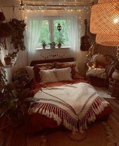 a bed room with a neatly made bed and lots of plants