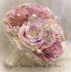 a bridal bouquet with pink flowers and pearls