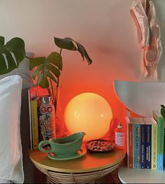 a table topped with books next to a lamp