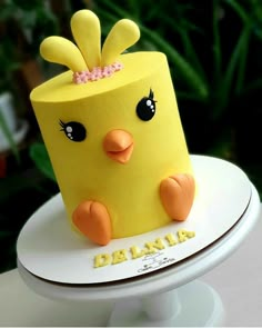 a cake that is shaped like a yellow bird