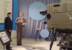 two men standing in front of a movie camera