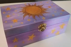 a purple box with gold stars painted on it