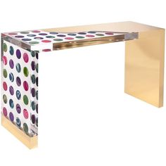 a table with polka dots on it and a gold frame around the edge that has been painted in different colors