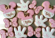 minnie mouse cookies are arranged in the shape of hearts and hands with name on them