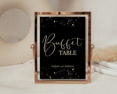 a black and gold wedding table name sign