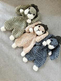 four knitted teddy bears laying on top of each other with one stuffed animal in the middle