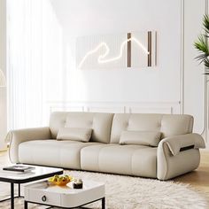 a modern living room with white furniture and rugs on the floor, along with a coffee table