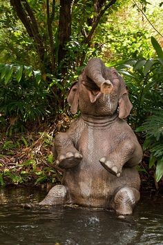 an elephant statue is sitting in the water