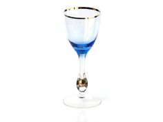 a blue wine glass sitting on top of a table