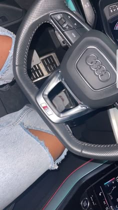 the interior of an audi car with its steering wheel and display screen showing various electronic devices