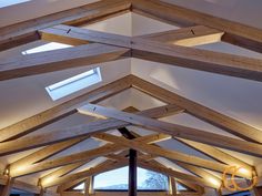 the inside of a building with wooden beams and windows on each side that have skylights