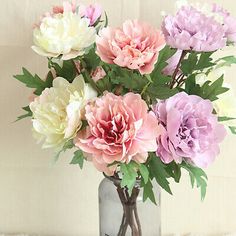 a vase filled with lots of pink and white flowers